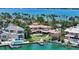 Gorgeous backyard featuring a waterfront with a private dock, a patio, and a beautifully landscaped lawn at 203 Robin Dr, Sarasota, FL 34236