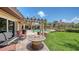 Backyard firepit area with outdoor seating, lush landscaping, and luxurious pool area at 203 Robin Dr, Sarasota, FL 34236