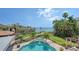 Lush backyard with sparkling pool and spa, and dock overlooking the water for ultimate relaxation and entertainment at 203 Robin Dr, Sarasota, FL 34236