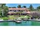 Elegant backyard showcasing a lush lawn, landscaped gardens, and a private dock on the water, perfect for outdoor living at 203 Robin Dr, Sarasota, FL 34236