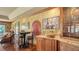 Home bar with granite countertops, custom cabinetry, and charming seating area for entertaining at 203 Robin Dr, Sarasota, FL 34236