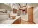 Spacious bathroom featuring dual mirrors, wood cabinets, a walk in tub and a shower, designed for comfort at 203 Robin Dr, Sarasota, FL 34236