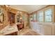 Lavish bathroom with a glass shower, soaking tub, double sinks, and vanity with designer fixtures and finishes at 203 Robin Dr, Sarasota, FL 34236
