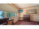 Bright room featuring a desk, dresser, and a large window offering natural light and scenic views of the outdoors at 203 Robin Dr, Sarasota, FL 34236