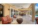 Spacious covered patio with seating and dining areas, perfect for entertaining with views of the pool and waterfront at 203 Robin Dr, Sarasota, FL 34236
