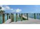 Modern dock featuring boatlifts, sturdy wooden supports, and serene water access, ideal for boating enthusiasts at 203 Robin Dr, Sarasota, FL 34236