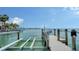 Dock featuring boat lift and waterfront views of the city skyline at 203 Robin Dr, Sarasota, FL 34236