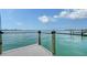 Waterfront view of a private boat dock on a clear day, offering stunning views of the serene water at 203 Robin Dr, Sarasota, FL 34236