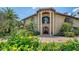 Majestic home with an impressive facade, grand columns, and vibrant floral landscaping at 203 Robin Dr, Sarasota, FL 34236