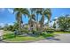 Beautiful home with meticulously maintained landscaping, lush green grass, and a stately fountain at 203 Robin Dr, Sarasota, FL 34236