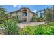 Impressive home showcasing lush landscaping, large stately pillars, and an inviting entrance at 203 Robin Dr, Sarasota, FL 34236