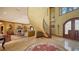 Grand foyer with a striking staircase, elegant flooring, and sophisticated decor, making a memorable first impression at 203 Robin Dr, Sarasota, FL 34236