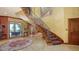 Stunning foyer with a winding staircase, water views, and refined details, creating an inviting and luxurious entrance at 203 Robin Dr, Sarasota, FL 34236