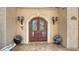 Elegant front entrance with double doors, detailed stonework, and decorative sconces at 203 Robin Dr, Sarasota, FL 34236