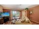 Inviting living room with tile floors, large windows, and comfortable seating, perfect for relaxing and entertaining at 203 Robin Dr, Sarasota, FL 34236