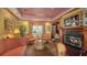 Comfortable living room featuring a fireplace, plush seating, and ornate decor with a warm ambiance at 203 Robin Dr, Sarasota, FL 34236