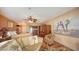 Comfortable living room with tile floors, ceiling fan, and open layout with access to the kitchen and bedroom at 203 Robin Dr, Sarasota, FL 34236