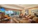 Relaxing living room featuring sliding doors that lead to the backyard overlooking the river at 203 Robin Dr, Sarasota, FL 34236