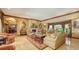 Elegant living room with fireplace, ornate decor, and neutral-toned sofas, offering a luxurious and inviting space at 203 Robin Dr, Sarasota, FL 34236