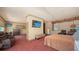 Spacious bedroom featuring a large bed, seating area, and mounted TVs for ultimate relaxation and entertainment at 203 Robin Dr, Sarasota, FL 34236