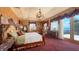 This spacious main bedroom suite offers water views, a decorative chandelier, and elegant curtains at 203 Robin Dr, Sarasota, FL 34236