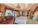 Serene main bedroom with attached bathroom, a decorative chandelier, and access to a private balcony at 203 Robin Dr, Sarasota, FL 34236