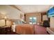 Comfortable bedroom with a view to the outdoor pool, and an armchair, providing a tranquil retreat at 203 Robin Dr, Sarasota, FL 34236