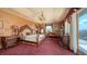 Bright and airy main bedroom with balcony access, chandelier, and gorgeous water views at 203 Robin Dr, Sarasota, FL 34236