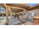 Outdoor grill and covered patio area with a large stainless steel gas grill and waterfront views at 203 Robin Dr, Sarasota, FL 34236
