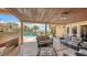 A stunning view of a covered patio with a fireplace, seating area, pool, and beautiful waterfront scenery at 203 Robin Dr, Sarasota, FL 34236