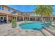 Backyard pool and spa featuring travertine deck and expansive patio at 203 Robin Dr, Sarasota, FL 34236