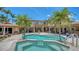 Expansive backyard with pool, spa, and covered patio seating areas at 203 Robin Dr, Sarasota, FL 34236