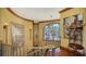 Ornate staircase with decorative art, a chandelier, and a large window offering scenic views and sophisticated design at 203 Robin Dr, Sarasota, FL 34236