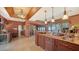 Open floorplan features an island with a marble countertop, wine cooler, and backyard view at 203 Robin Dr, Sarasota, FL 34236