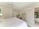 Bright bedroom featuring neutral decor, a ceiling fan and a glimpse of the adjoining space at 216 Matisse Cir, Nokomis, FL 34275