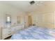 Bedroom with light walls, ceiling fan, dresser and closet at 216 Matisse Cir, Nokomis, FL 34275