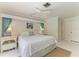 Bright bedroom featuring a ceiling fan, neutral decor, and a comfortable bed with crisp white linens at 216 Matisse Cir, Nokomis, FL 34275