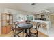 Eat-in breakfast nook with convenient kitchen access and views of the pool via large glass doors at 216 Matisse Cir, Nokomis, FL 34275