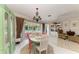 Charming dining room featuring a vintage chandelier, views of the pool and access to the lanai at 216 Matisse Cir, Nokomis, FL 34275