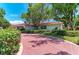 Lovely single-story home displaying a wide driveway, lush lawn and mature trees at 216 Matisse Cir, Nokomis, FL 34275