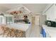 Open concept kitchen with breakfast bar seating, stainless appliances and easy access to the lanai and pool at 216 Matisse Cir, Nokomis, FL 34275