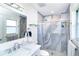 Bathroom featuring a luxurious marble vanity and walk-in shower with decorative tile and shower niche at 217 Mariner Ln, Rotonda West, FL 33947