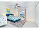 Neutral guest bedroom with ceiling fan, arched window for natural light, and white tile flooring at 217 Mariner Ln, Rotonda West, FL 33947