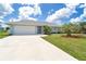 Charming single-story home with a well-manicured lawn, landscaping, and a two-car garage at 217 Mariner Ln, Rotonda West, FL 33947
