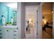 Hallway showing view of bathroom with updated fixtures and bedrooms with ceiling fans at 217 Mariner Ln, Rotonda West, FL 33947