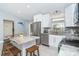 Modern kitchen features an island with bar seating, stainless steel appliances, and granite counters at 217 Mariner Ln, Rotonda West, FL 33947