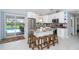Bright kitchen featuring white cabinets, stainless steel appliances, and granite countertops, plus a breakfast bar with seating at 217 Mariner Ln, Rotonda West, FL 33947