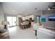 Open-concept living room and kitchen features stainless appliances, island with seating and tile flooring at 217 Mariner Ln, Rotonda West, FL 33947