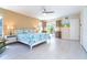 Bright main bedroom features tile floors, ceiling fan, king bed, and sliding glass doors to the outdoor space at 217 Mariner Ln, Rotonda West, FL 33947