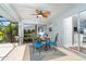 Inviting screened patio with dining set and fan, offering a view of the pool and backyard at 217 Mariner Ln, Rotonda West, FL 33947